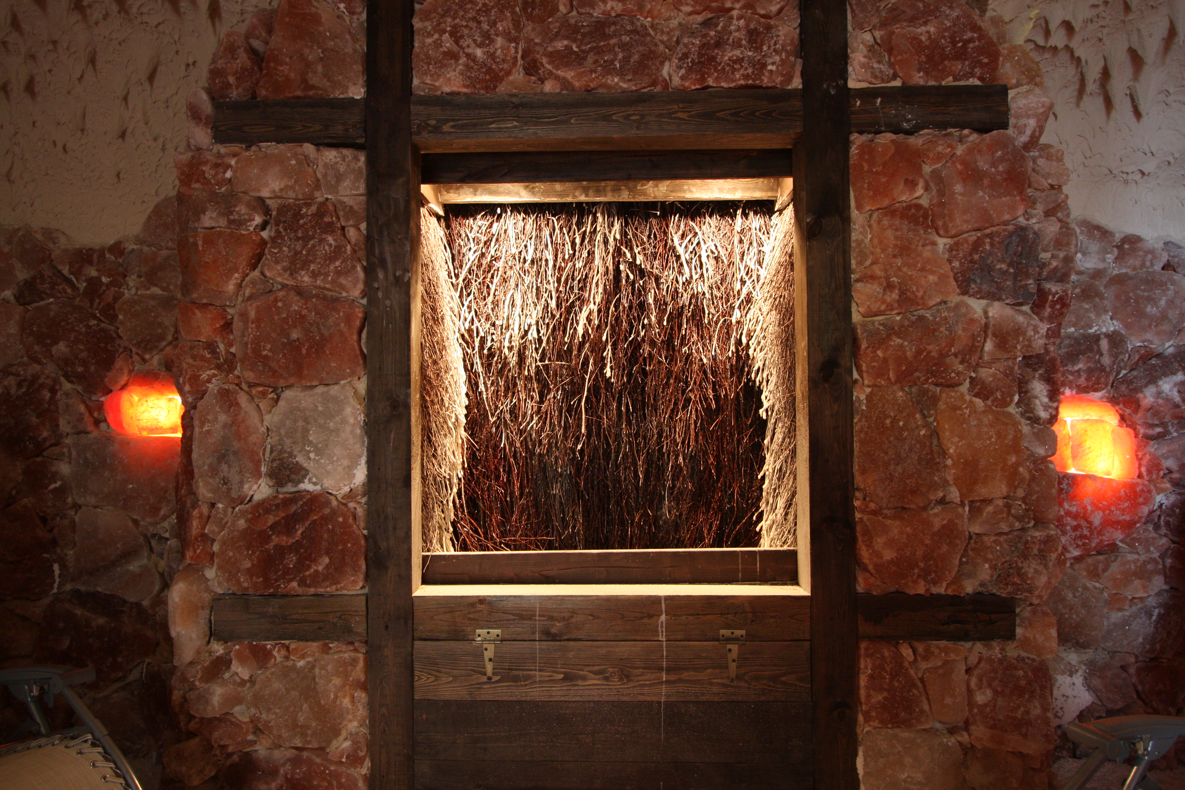 Graduation tower with branches surrounded by rock walls